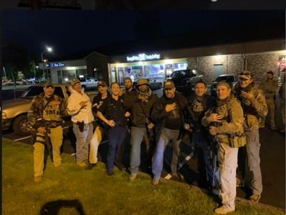 Three Percenters Pose with Olympia Police Officer, Sparks Need for Thorough Investigation